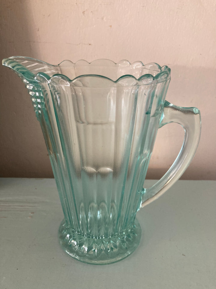 Vintage 1930s green pressed glass jug with fluted design, perfect for beverages or as a decorative vase.