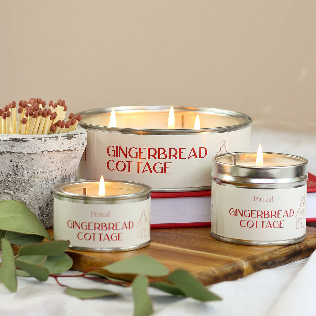 Pintail Candles Gingerbread Cottage Classic Tin Candle with the aroma of cinnamon, nutmeg, and ginger, displayed with rustic decor