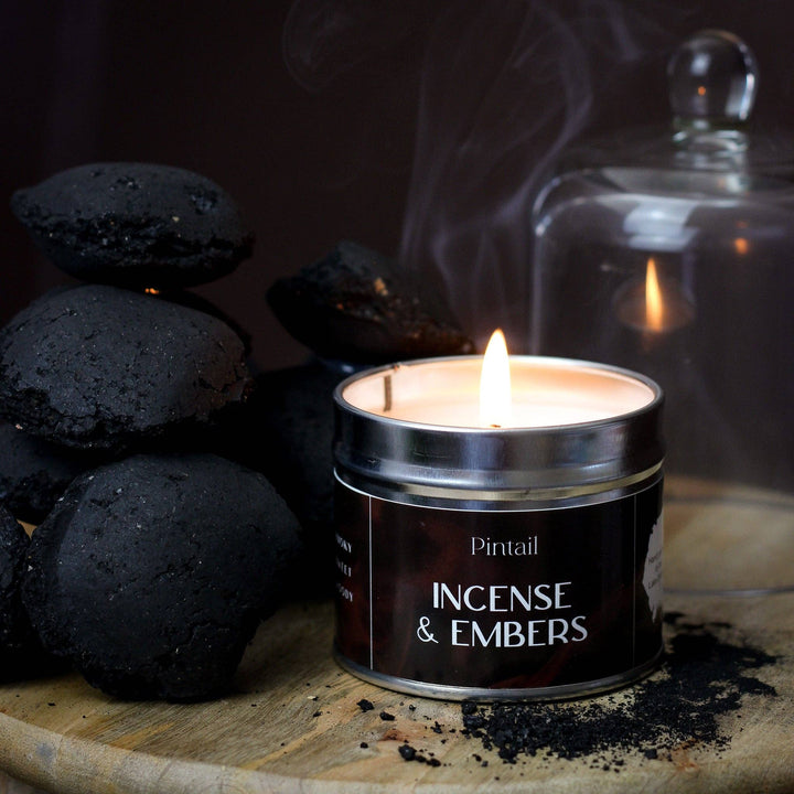 Pintail Candles Incense & Embers Classic Tin Candle with flames and black charcoal, available at Source for the Goose, Devon.