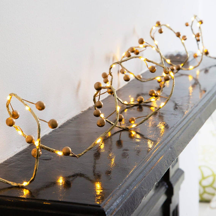 Christmas Gold Berry String of LED Lights on mantelpiece, 40 warm white lights, elegant decor from Source for the Goose Devon.