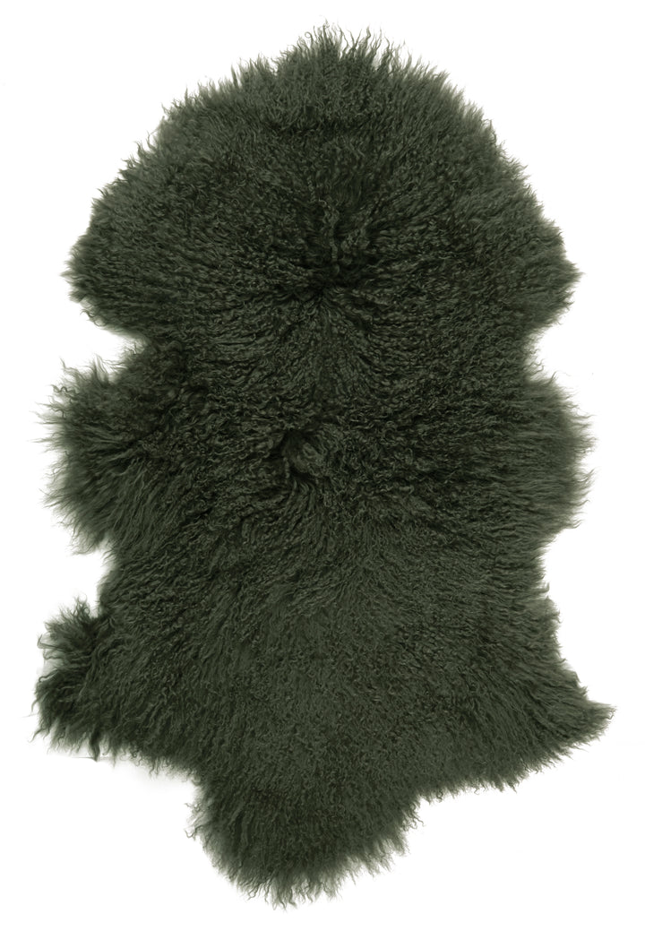 Luxurious dark green Tibetan lamb fur throw with lush curly texture from Source for the Goose Devon, adding elegance to any space.