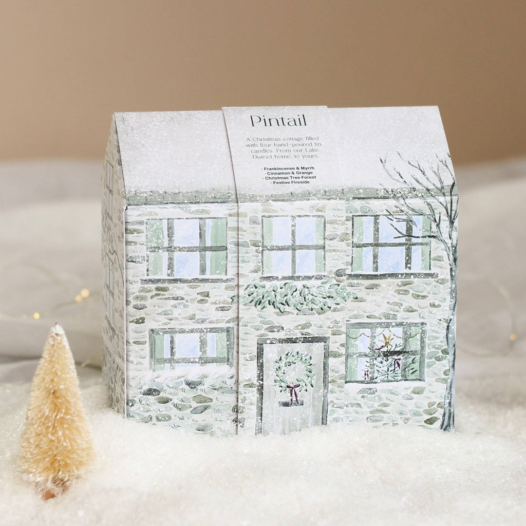 Pintail Candles Holiday Cottage Gift Set with four festive scents in a hand-drawn winter-themed box.