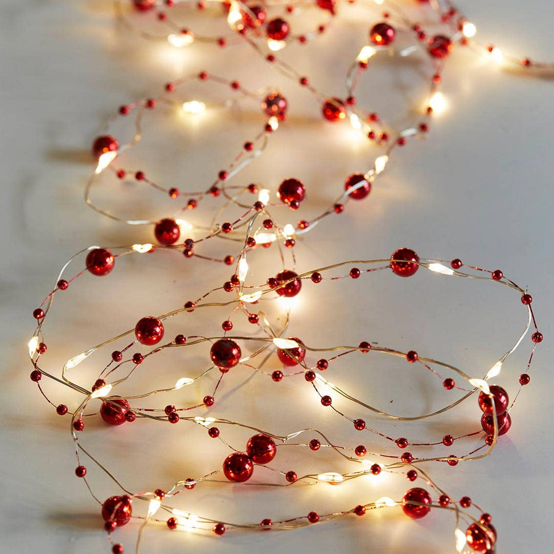 Red Berry Christmas String Lights on gold wire by Source for the Goose, Devon, creating a warm festive atmosphere.