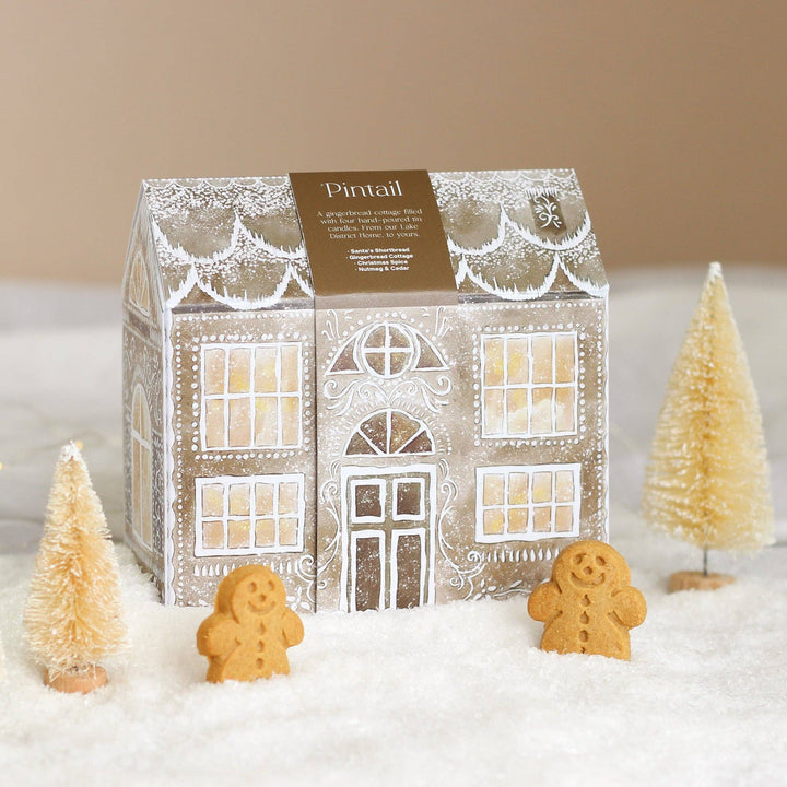 Pintail Candles Gingerbread Cottage Gift Set with festive scents displayed among miniature trees and gingerbread men - Source for the Goose, Devon