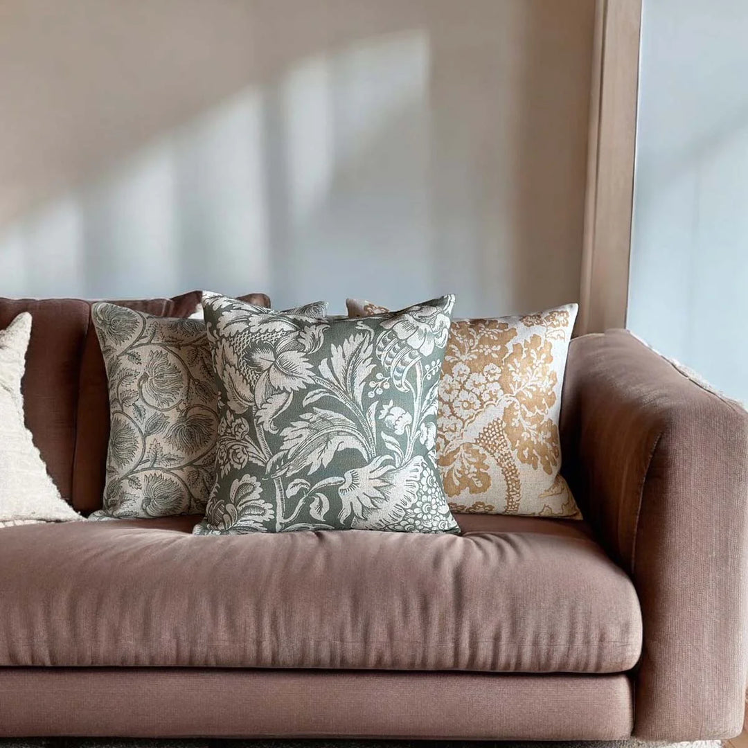 Cozy living room scene featuring Moss Green Acrimi Cushion with elegant patterns on a soft sofa, enhancing home décor.