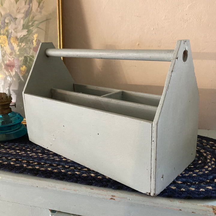 Vintage blue painted caddy from Source for the Goose, ideal for organizing art supplies with rustic charm.