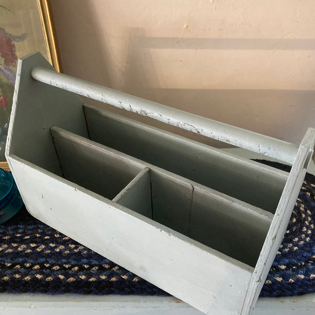 Vintage blue painted caddy showcasing rustic charm and storage for art supplies. From Source for the Goose, Devon.