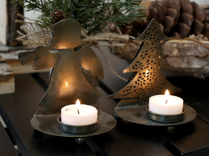 Brass angel tea light holder with Christmas tree design, glowing warmly with tea lights. Festive decor by Source for the Goose, Devon.