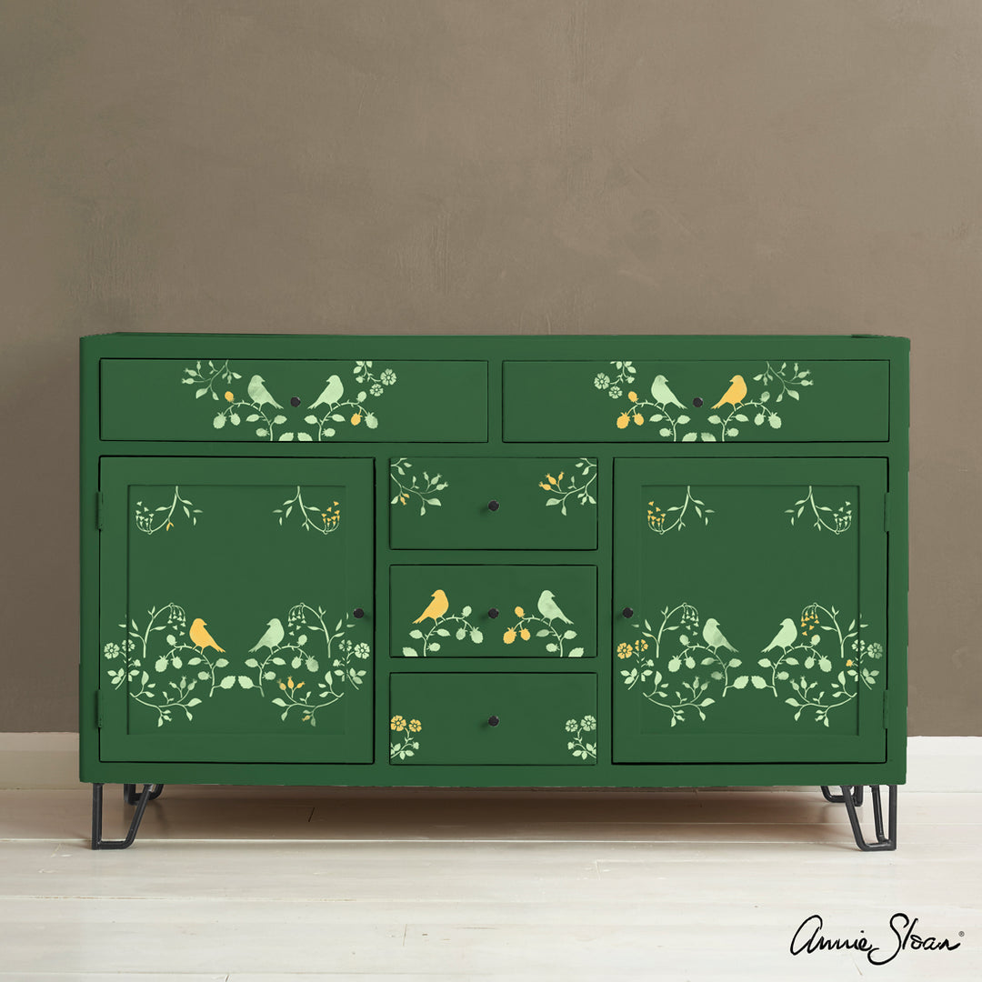 Annie Sloan Countryside Bird Stencil on green cabinet, inspired by English pastoral motifs, for a romantic farmhouse look.