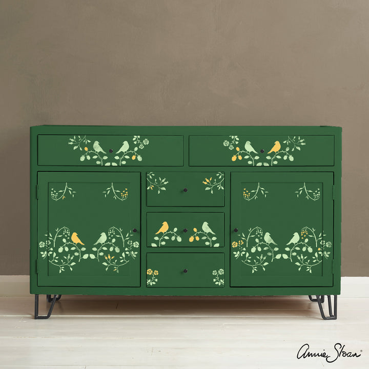 Annie Sloan Countryside Bird Stencil on green cabinet, inspired by English pastoral motifs, for a romantic farmhouse look.