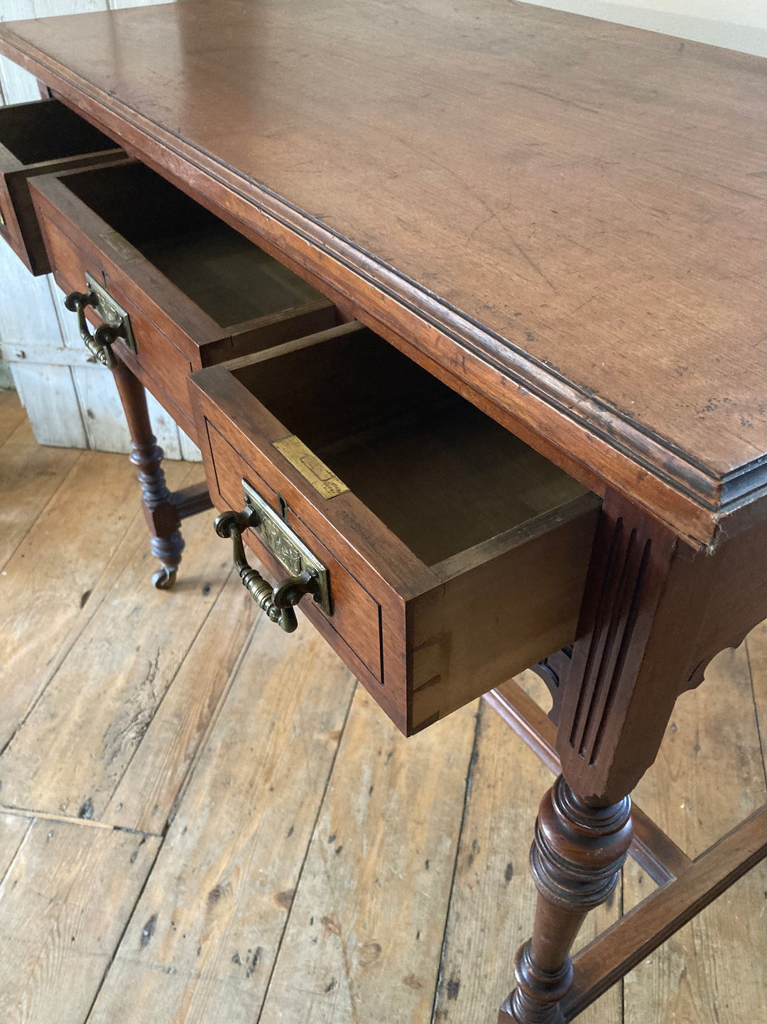 Antique Oak Console Table by JAS Shoolbred showcasing three drawers with brass drop handles, sourced from Source for the Goose Devon.