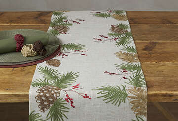 Embroidered Pine Cone Table Runner on wooden table, featuring pine cone and greenery design, perfect for Christmas decor from Source for the Goose Devon