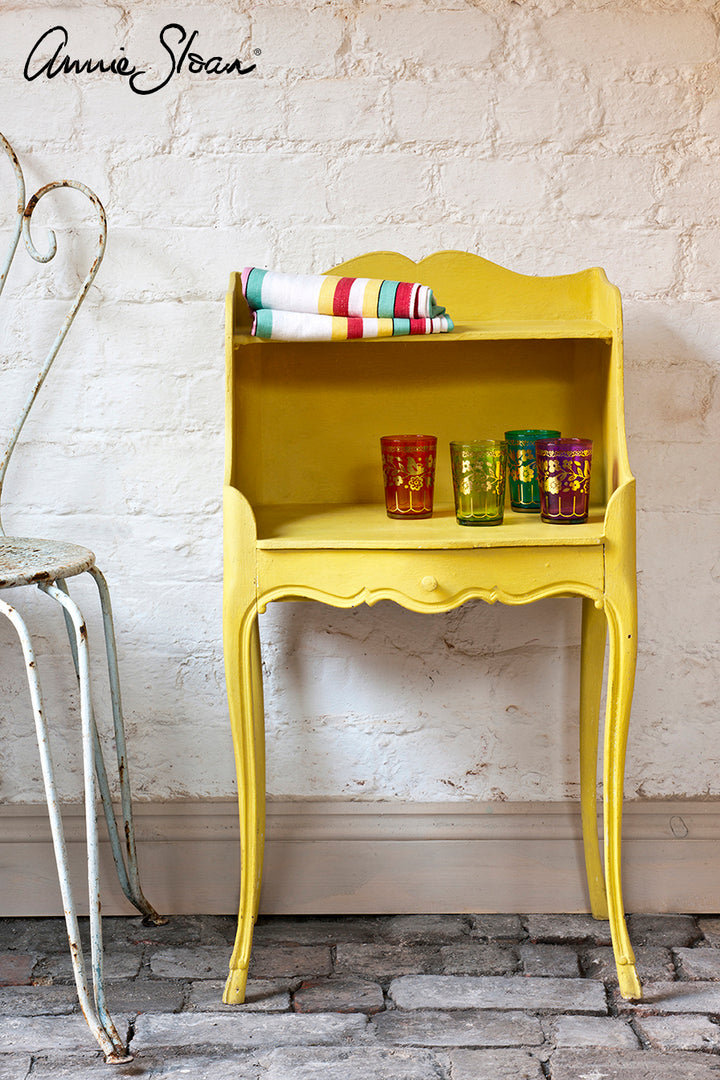 Vintage table painted in English Yellow Chalk Paint by Annie Sloan, styled with colorful glasses, featured at Source for the Goose Devon.