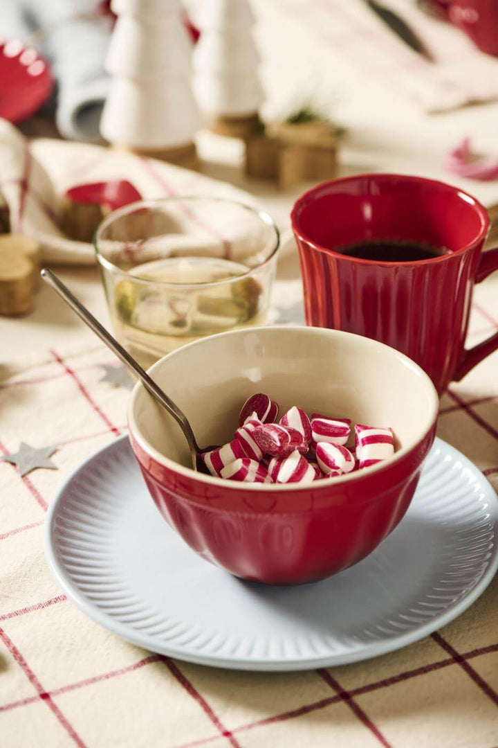 small red muesli bowl being used to display festive treats