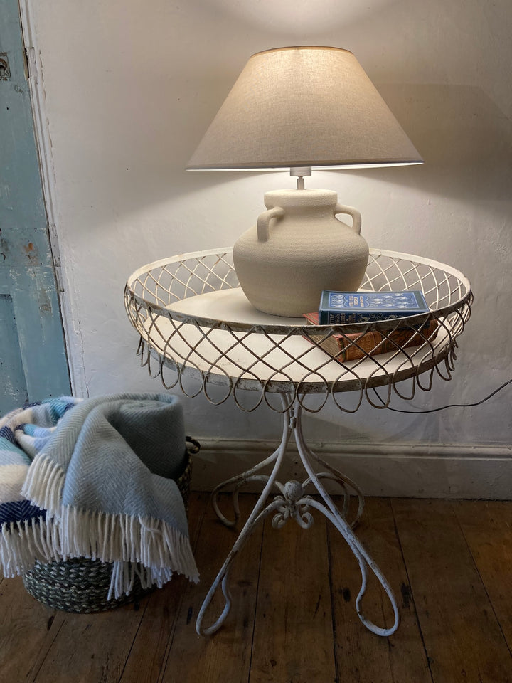 French Style Metal Side Table with lamp, vase, and book, showcasing charm and elegance in home decor.