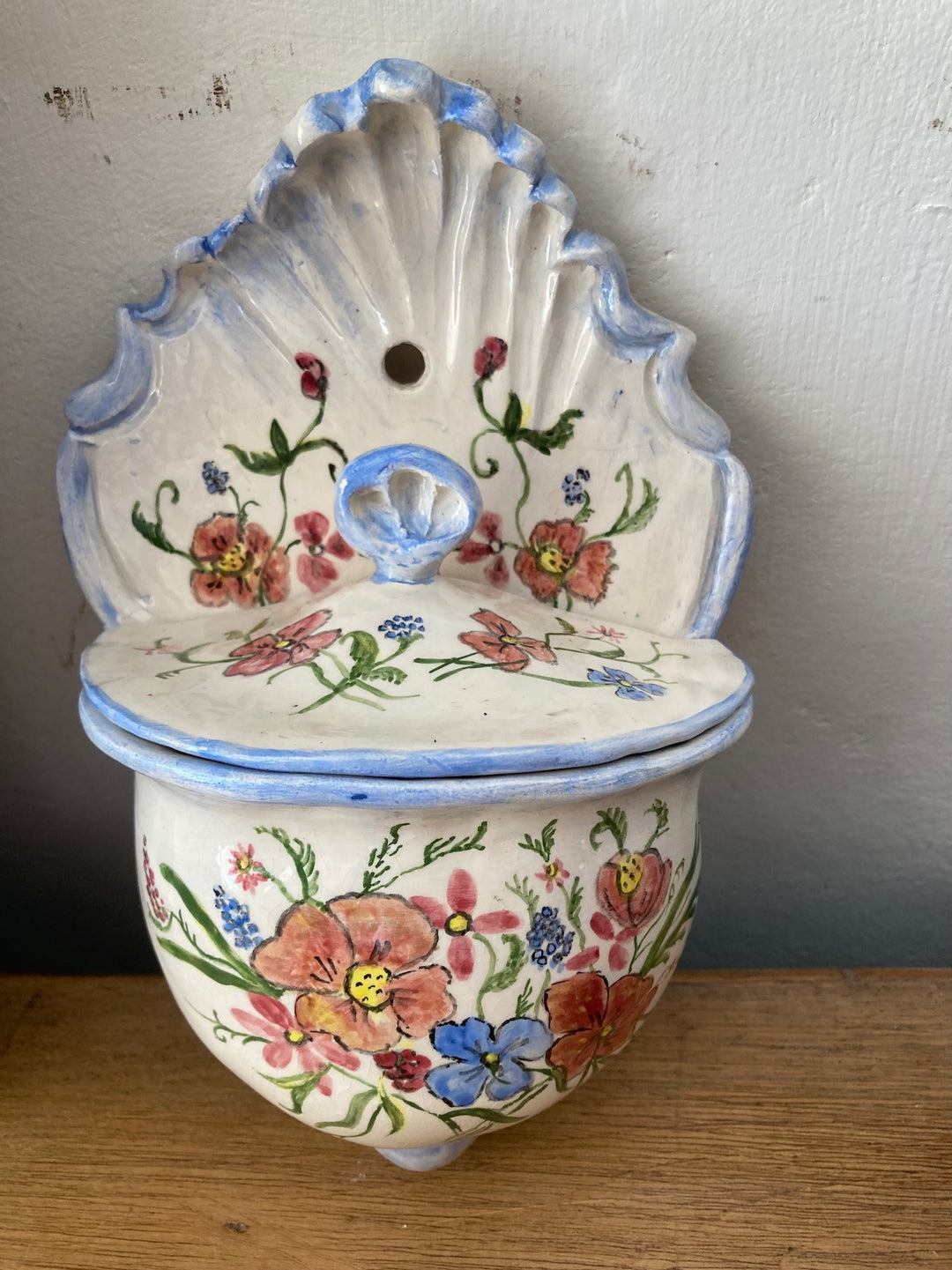 Hand painted ceramic wall sconce with floral design, perfect for decor or as a holy water receptacle from Source for the Goose, Devon.