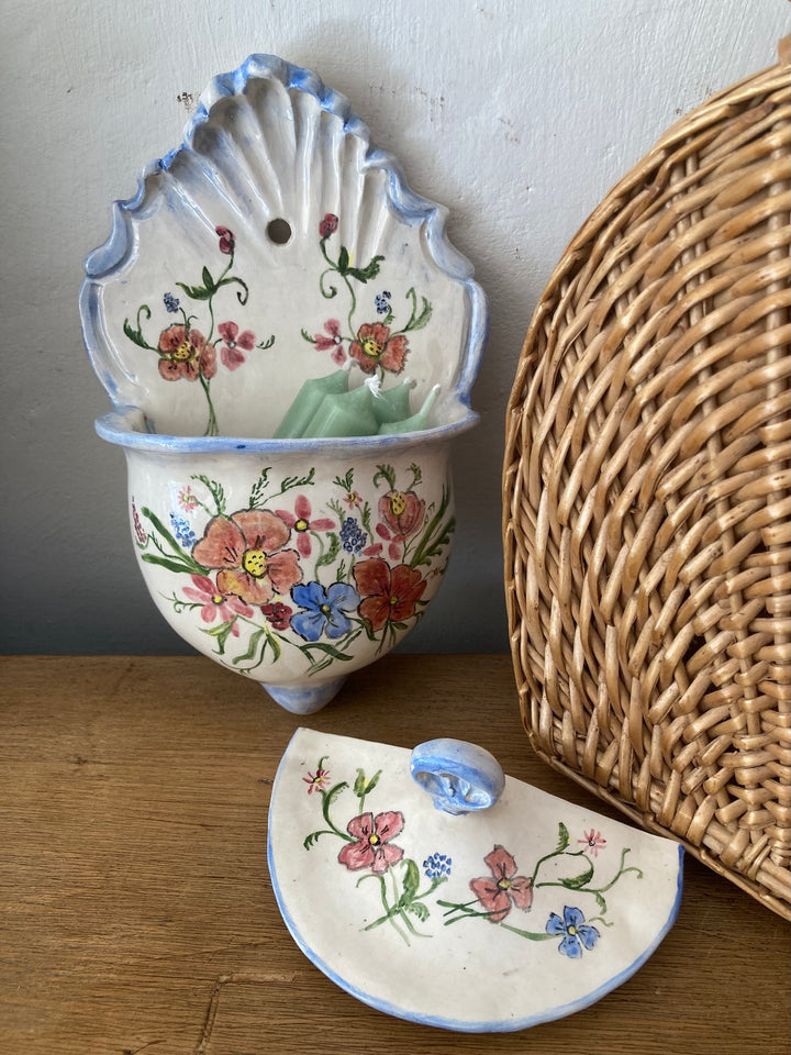 Hand painted ceramic wall sconce with floral design and blue trim, perfect for decoration or fresh flowers. Source for the Goose, Devon.