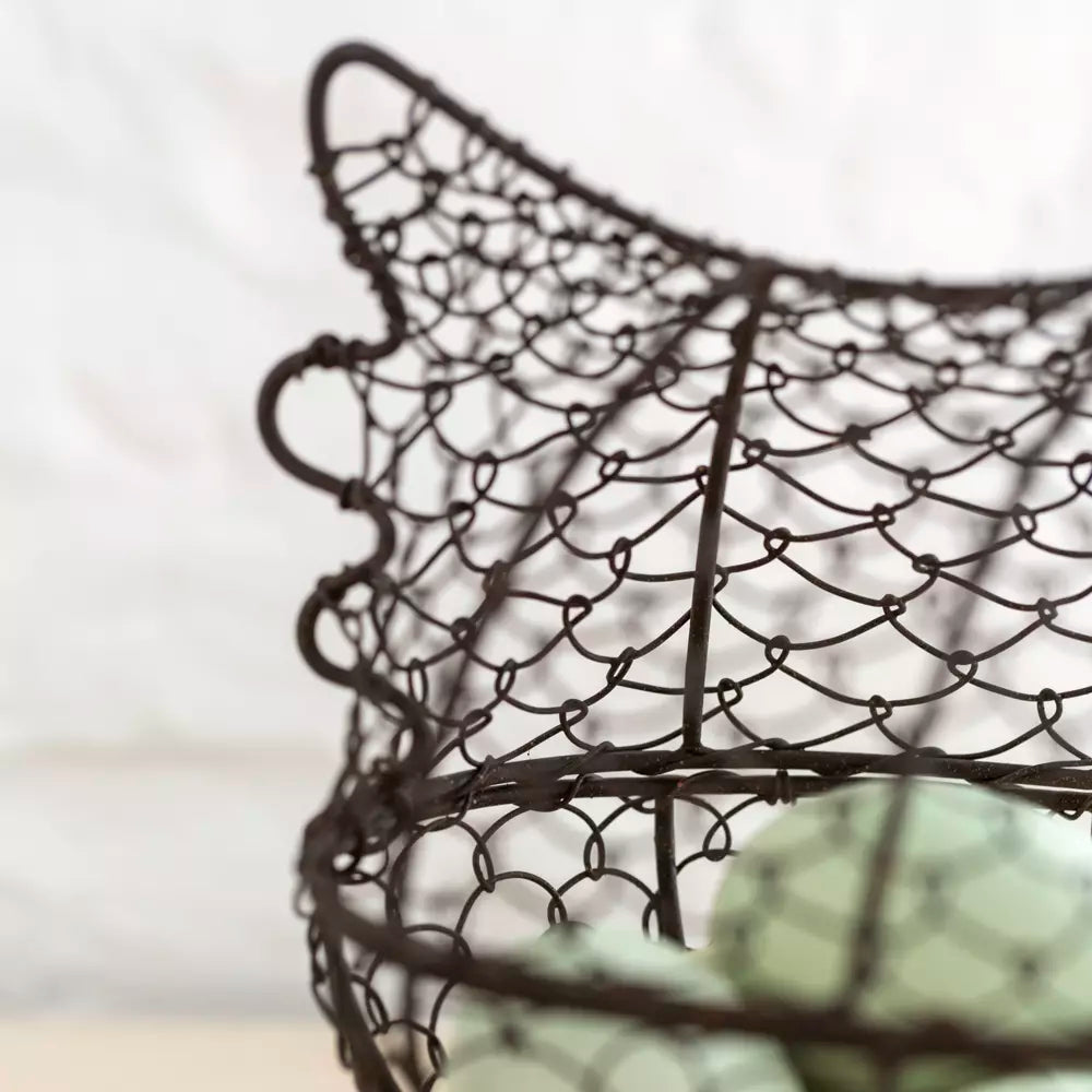 Close-up of Henrietta Wire Egg Basket from Source for the Goose, Devon featuring intricate chicken design and green eggs