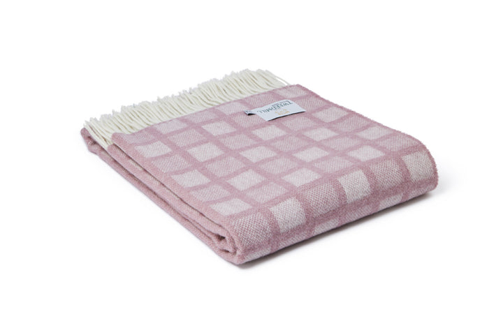 Tweedmill Sunken Pink Manhattan Wool Throw with cream tassels, featuring a pastel pink square pattern. Available at Source for the Goose, Devon.