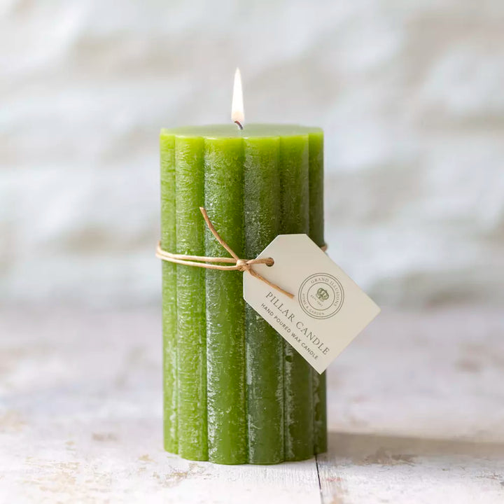 Rustic fern green scalloped pillar candle by Source for the Goose, beautifully lit for home decor enhancement.