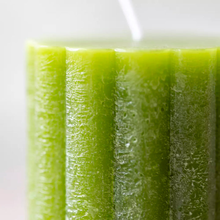 Close-up of a fern green scalloped pillar candle, showcasing its textured surface and vibrant color by Source for the Goose, Devon.