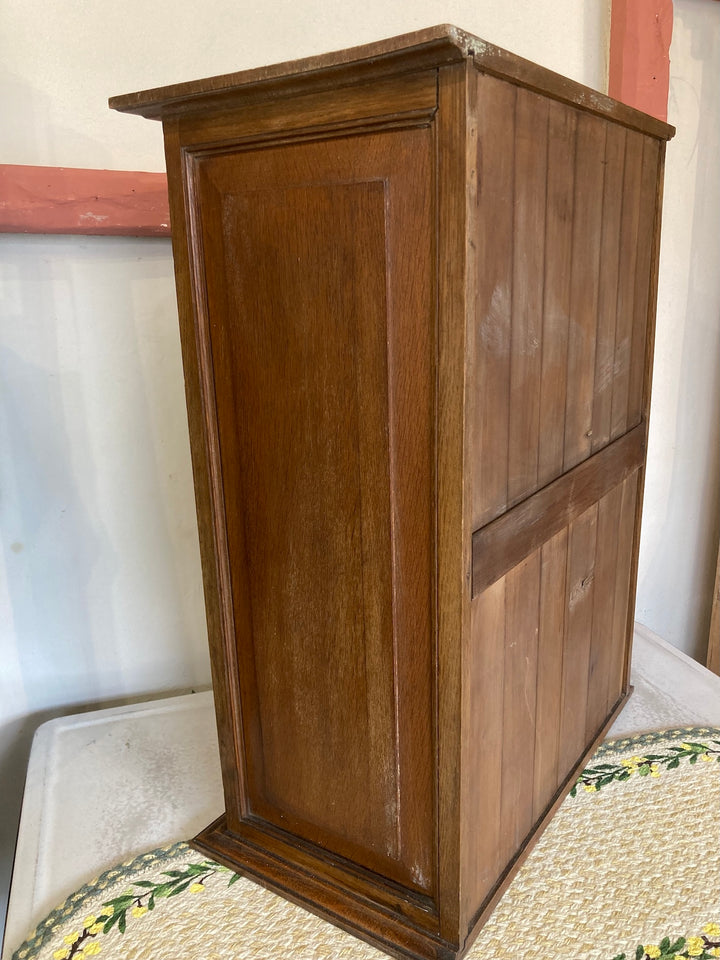 Small vintage glass cabinet with wooden finish, perfect for organizing and displaying collectibles. Source for the Goose, Devon.