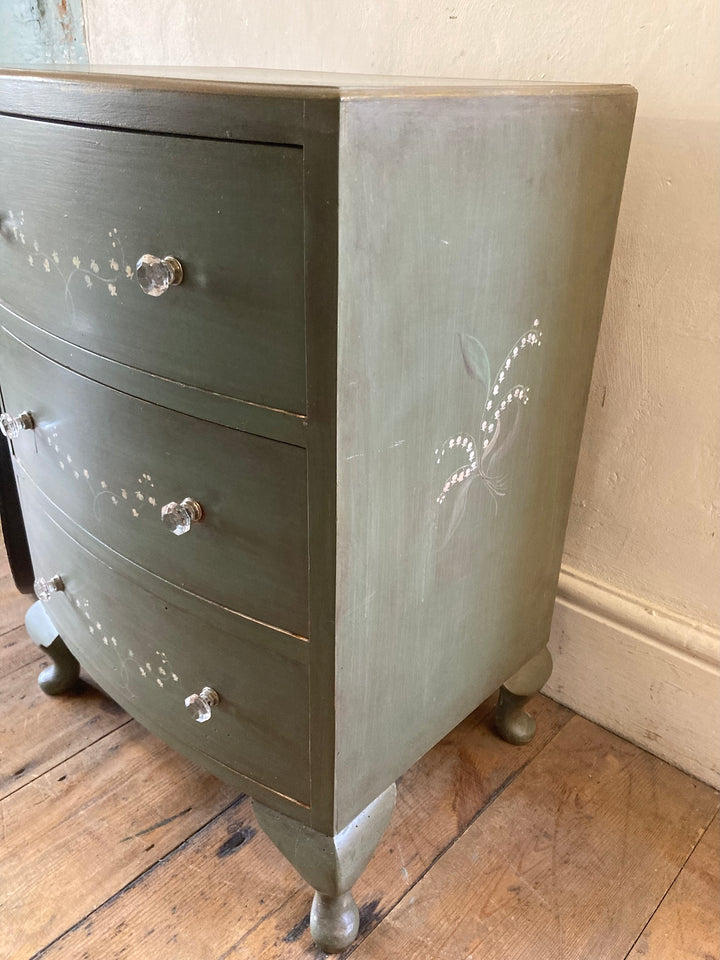 Small chest of drawers with hand painted lily of the valley flowers, green finish, and French style legs from Source for the Goose, Devon.