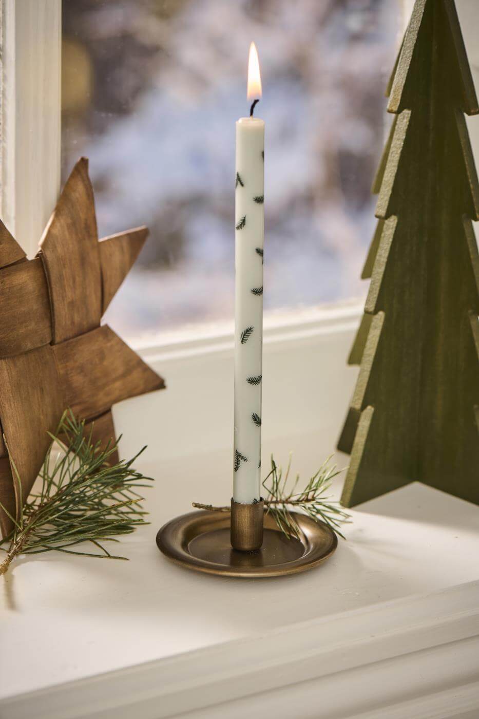 tall, simple festive candle in a brass candle holder, Source for the Goose Devon