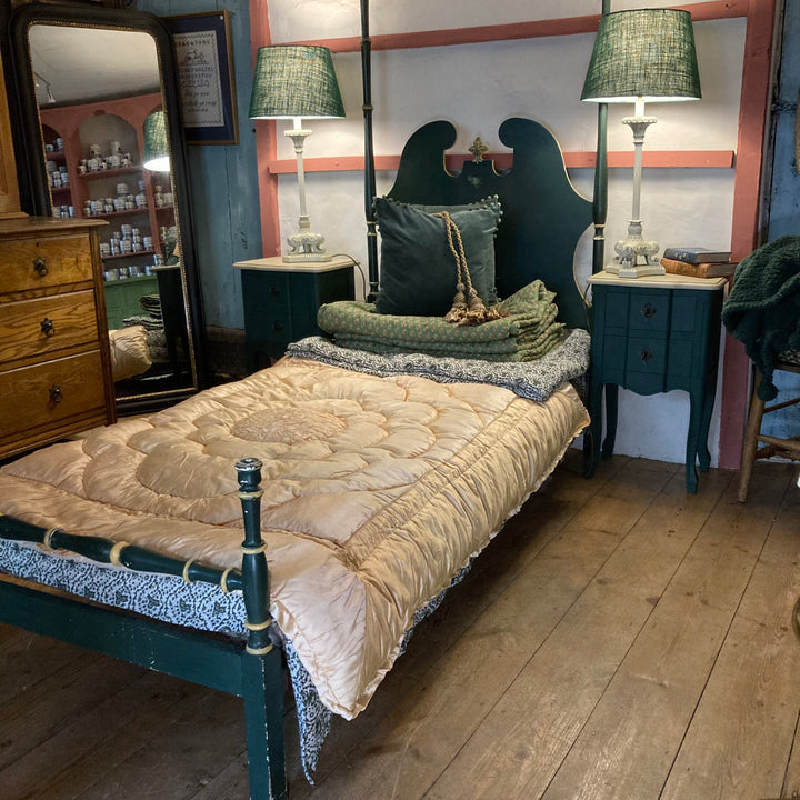 Vintage French green single bed with decorative quilt and lamps, showcasing charming bedroom style from Source for the Goose, Devon.