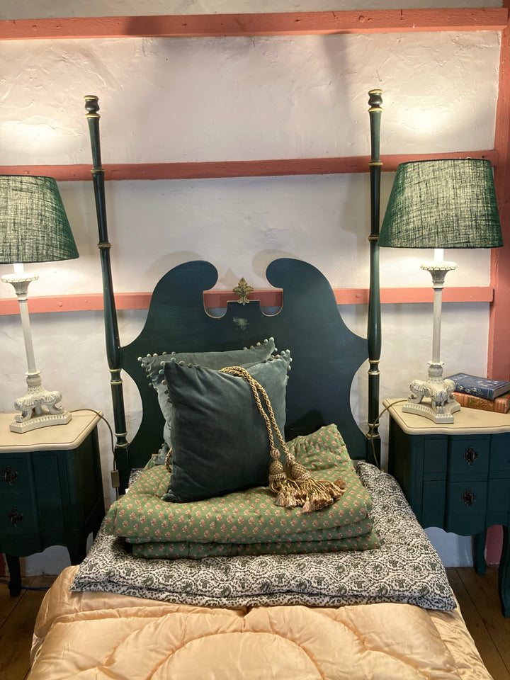 Vintage French green single bed with unique headboard, blankets, and stylish lamps from Source for the Goose, Devon.