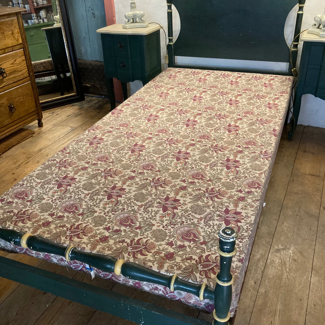 Vintage French green single bed with floral mattress, adding charm to any child's bedroom. Source for the Goose, Devon.