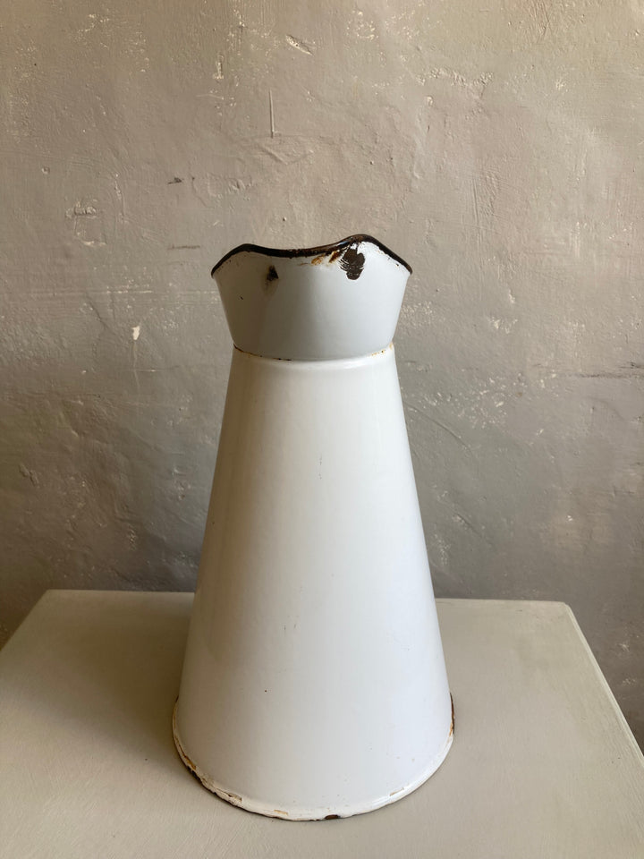 white enamel pitcher with black rim