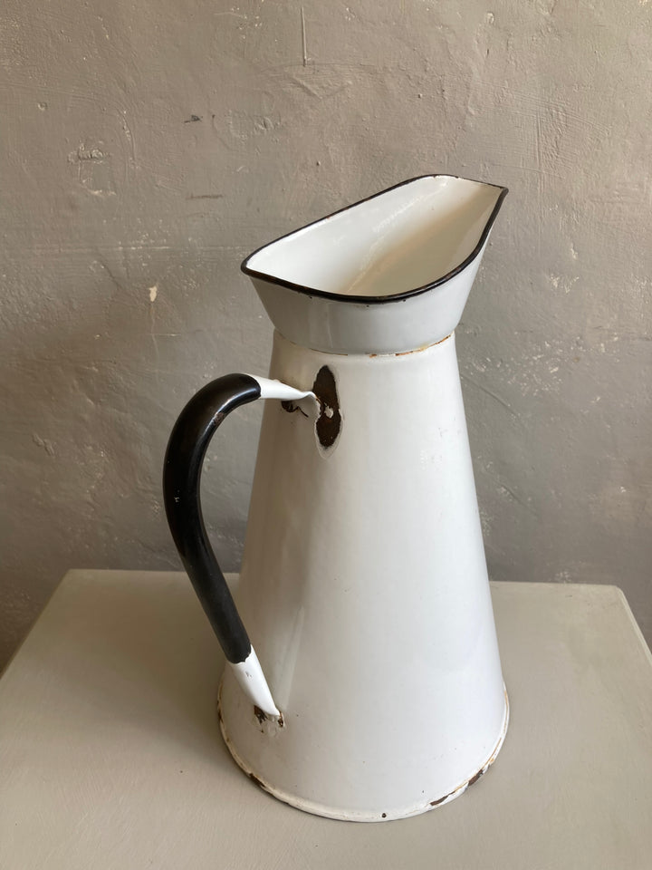 white enamel jug with black handle and rim