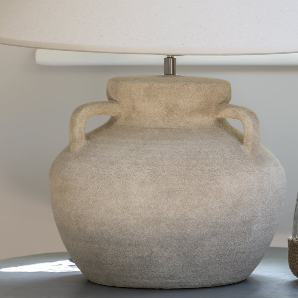 Stoneware Amphora Lamp with cream shade from Source for the Goose Devon, showcasing textured surface and neutral tones on lamp table.