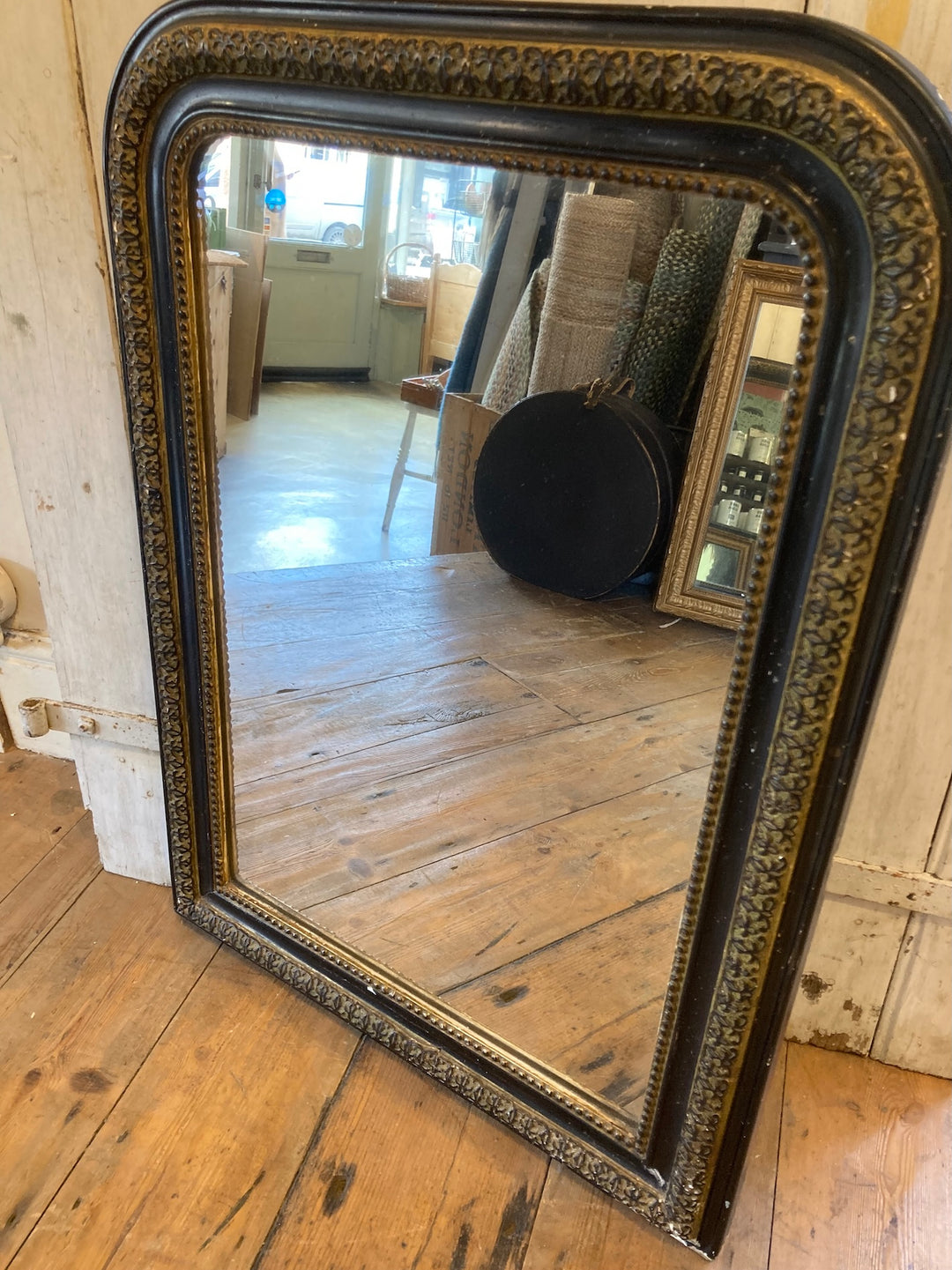 Vintage Arch Top French Mirror with distressed black frame and gold trim, perfect for any room. Source for the Goose, Devon.