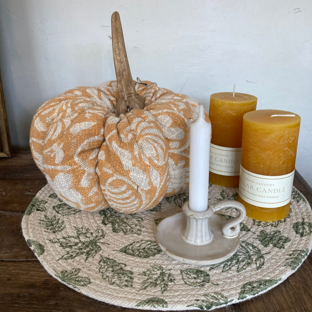 Circular Autumn Leaf Placemat with candles and a fabric pumpkin on a wooden table by Source for the Goose in Devon