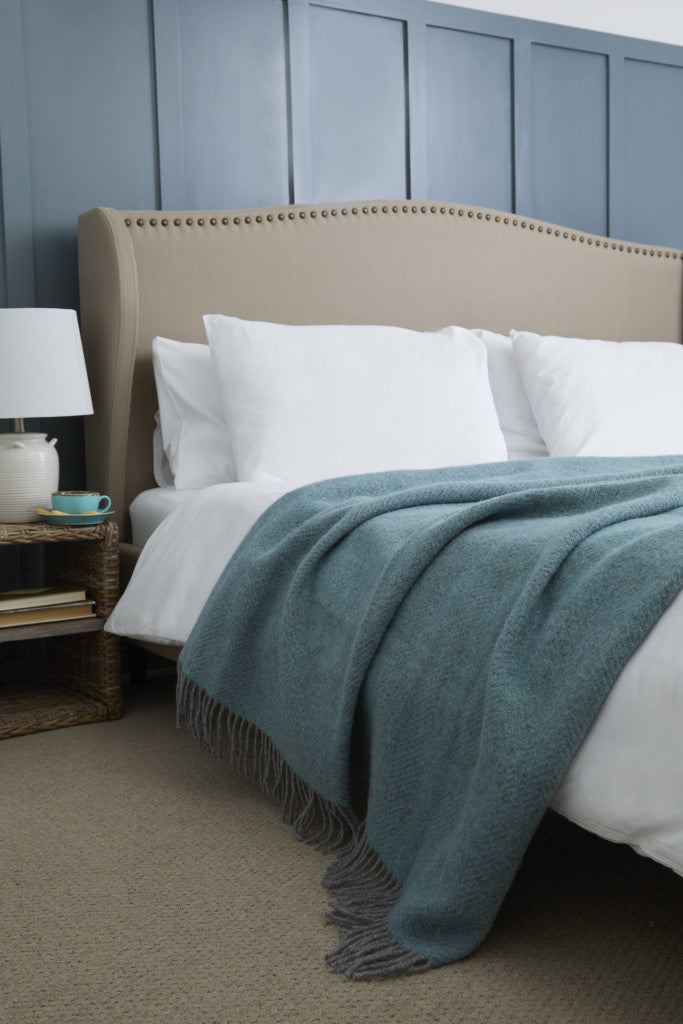 Beehive Spearmint & Grey Pure Wool Throw on a bed in a rustic bedroom from Source for the Goose Devon.