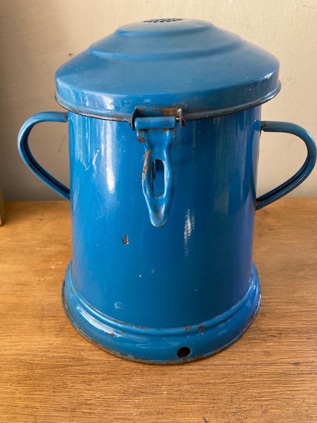 Vintage blue enamel bucket with lid, featuring rustic design and two handles, ideal for French country kitchen decor.