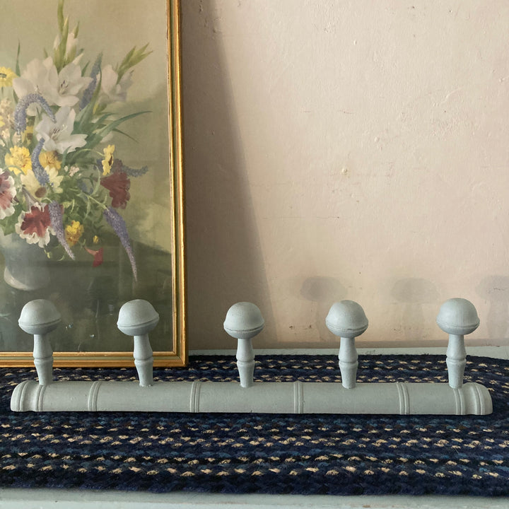 Blue Painted Faux Bamboo Coat Hooks on display with floral artwork, showcasing five round hooks for stylish organization.