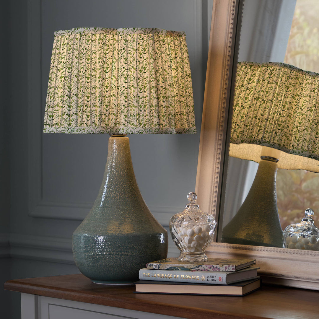 Juna pleated scalloped lamp shade in sage on a stylish lamp, enhancing home decor with elegance and artisanal design.