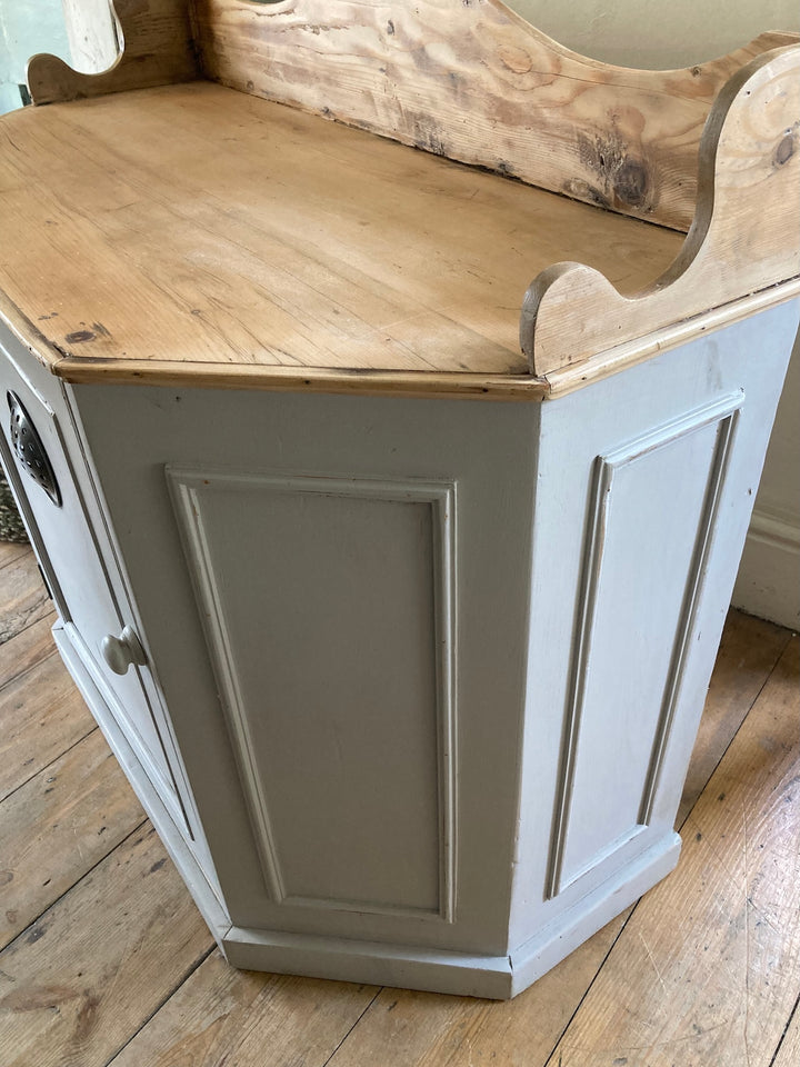 Vintage pantry cupboard with air vent in soft grey, showcasing a pine top and charming design for kitchen storage.