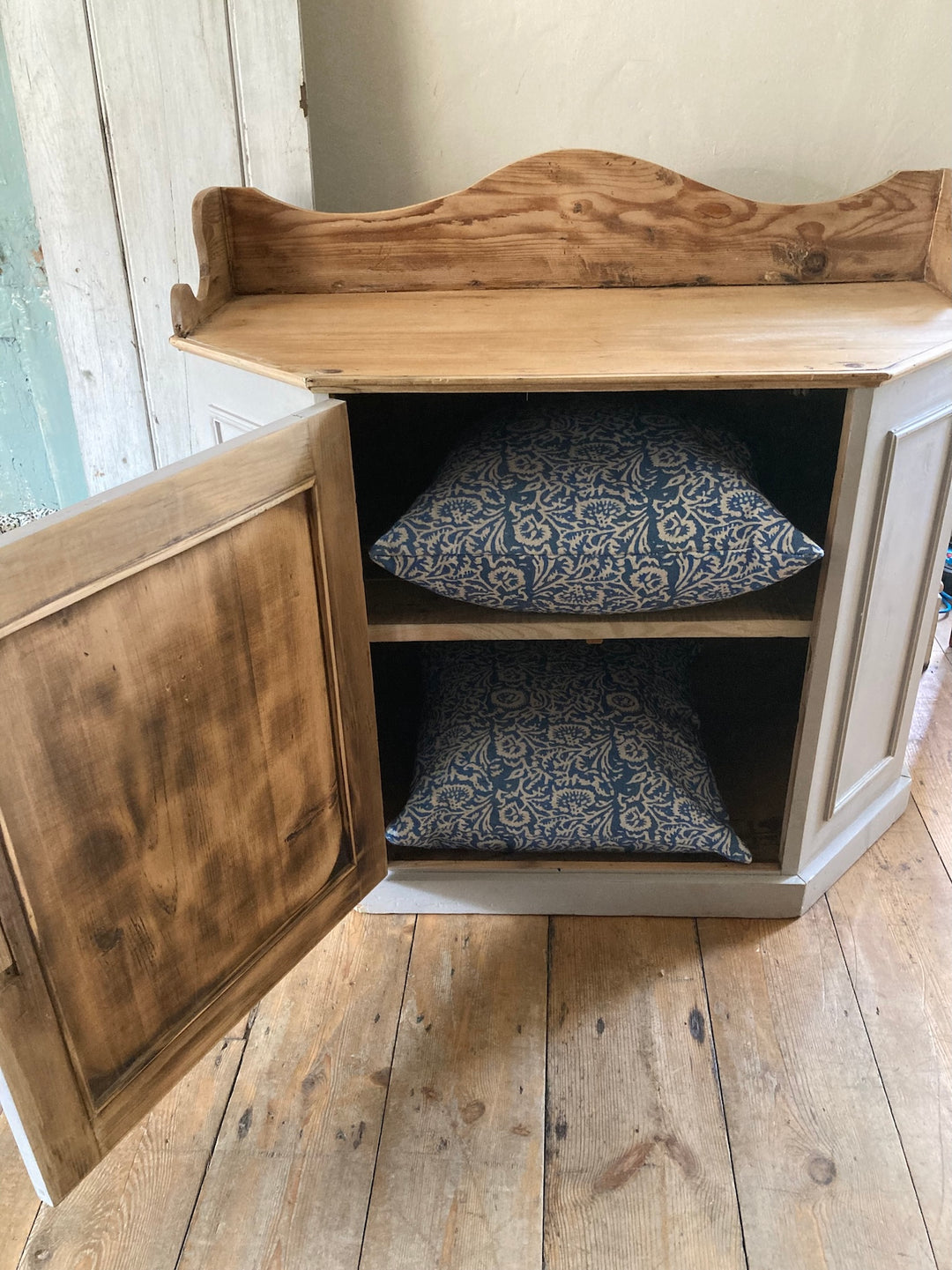 Vintage Pantry Cupboard with air vent, soft grey finish, open door revealing blue patterned cushions inside, Source for the Goose Devon.