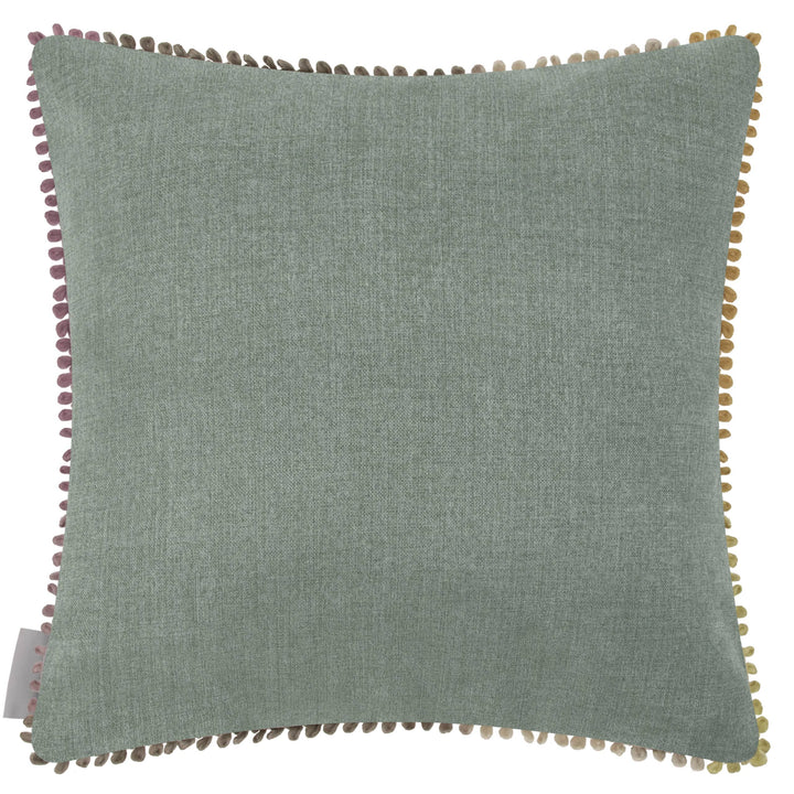 Small hedgerow cushion in soft green with colorful pom-pom trim, perfect for rustic decor by Source for the Goose, Devon.