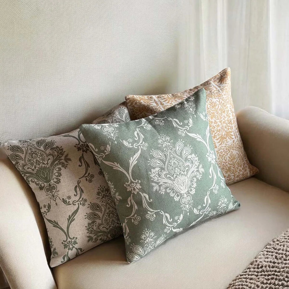 Sage Green Damask Cushion on a sofa, adding elegance to home decor, by Source for the Goose Devon.