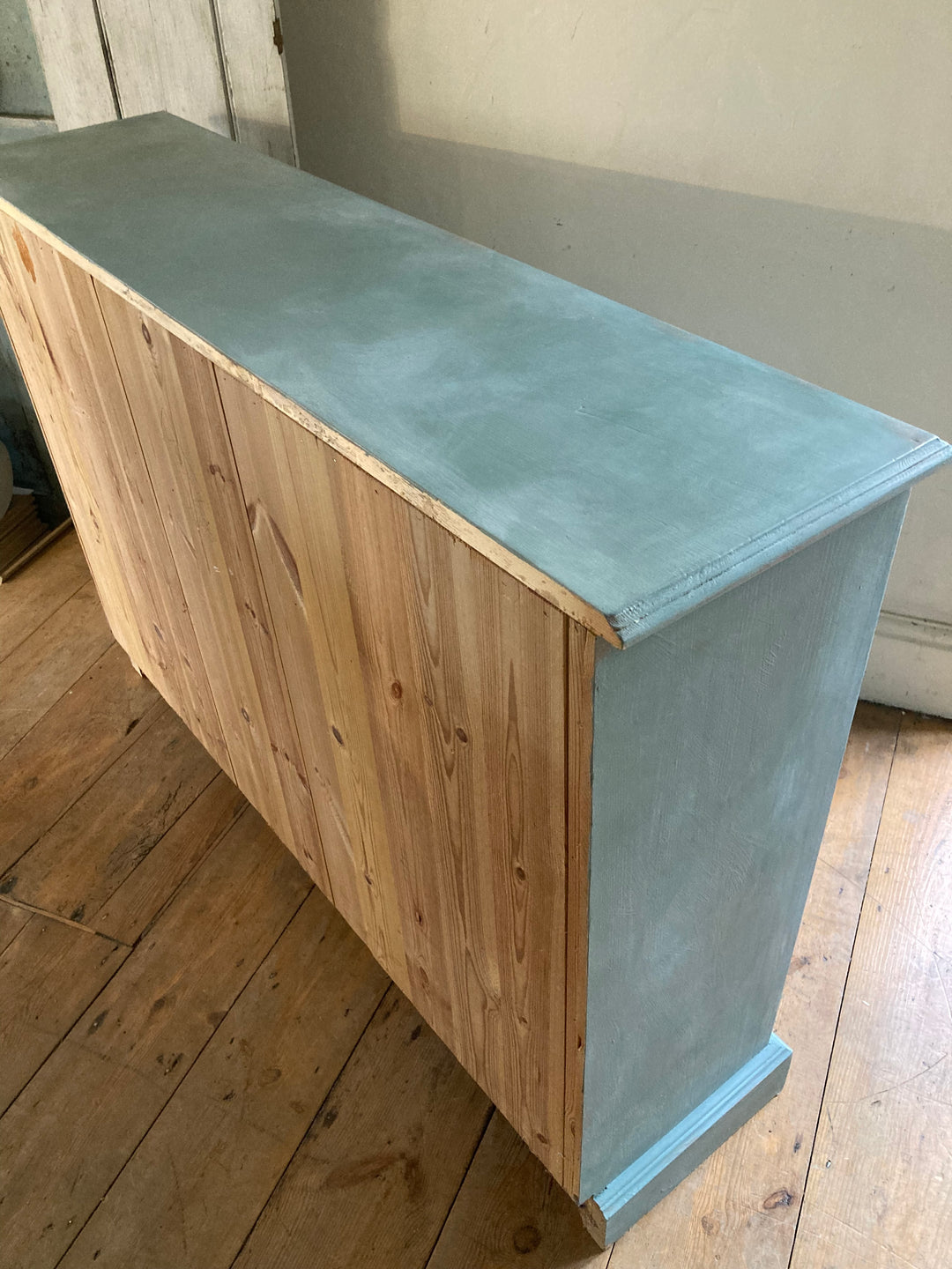 Side view of a slim duck egg blue sideboard with a natural wood finish, featuring a vintage charm for home decor.