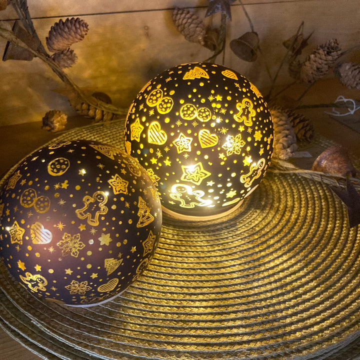 two sizes of glass globe with gingerbread design for sale at Source for the Goose, Devon