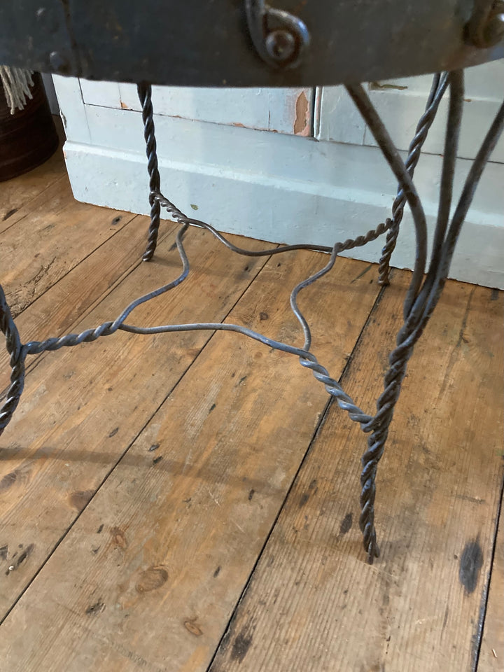 Handmade metal bistro chair with twisted frame detail, showcasing rustic elegance from Source for the Goose in Devon.