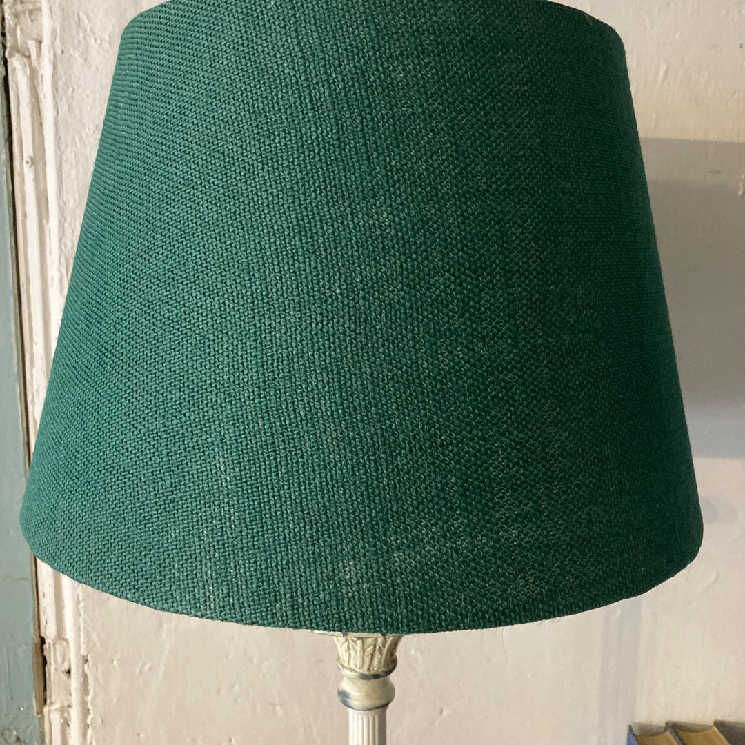 Green fabric lampshade on cream metal base lamp, adding elegance and warmth to any room. Source for the Goose, Devon.