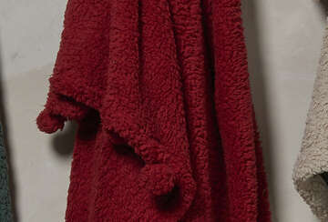 Deep red Cosy Pom Pom Throw showcasing soft, velvety texture with whimsical pom poms, from Source for the Goose, Devon.