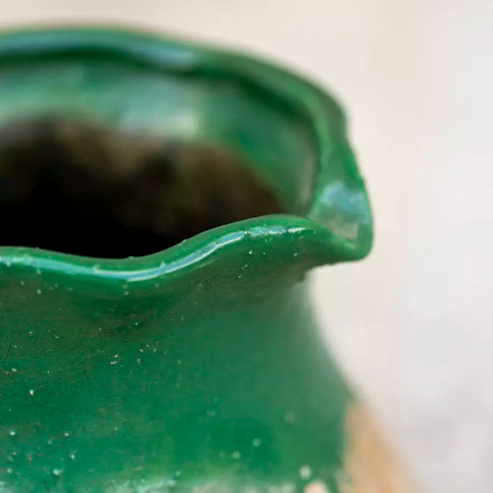 Rustic green terracotta jug with vintage design and rich green glaze, showcasing its detailed sturdy spout and natural, earthy base.